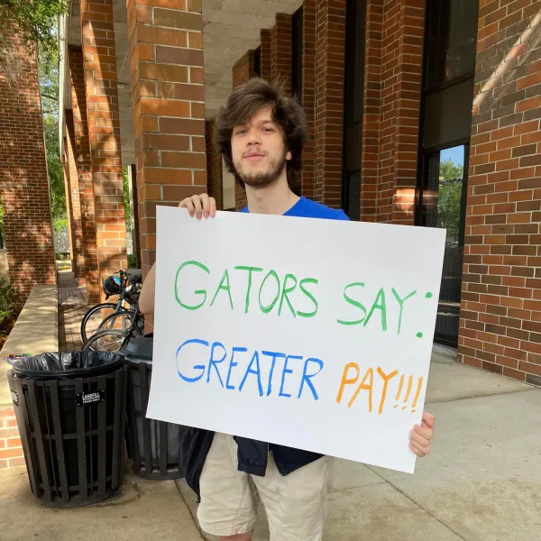 A worker holding a sign. 