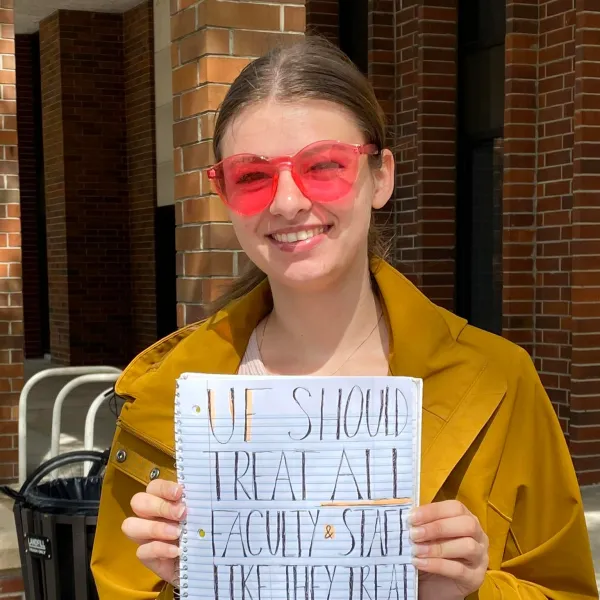 A worker holding a sign. 